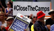 A file photo of the protesters from the Refugee Action Coalition hold placards during a demonstration outside the offices of the Australian Government Department of Immigration and Border Protection in Sydney, Australia, April 29, 2016. Reuters/David Gray