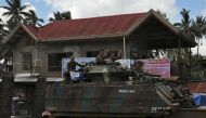Government soldiers wave while atop of the tank after the send-off ceremony ending their combat duty against pro-Islamic State militant groups, after President Rodrigo Duterte announced the liberation of Marawi city on Monday, in Saguiaran, Lanao Del Sur,