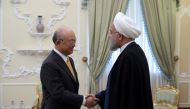 A file photo of a handout picture provided by the office of Iranian President Hassan Rouhani on October 29, 2017 shows him (R) greeting Director General of the International Atomic Energy Agency (IAEA), Yukiya Amano (L) ahead of their meeting in Tehran. A