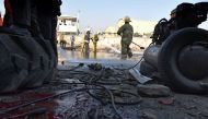 This file photo taken on December 27, 2015 shows Afghan firefighters washing a road at the site of a suicide car bomb perpetrated by a Taliban bomber near the international airport in Kabul. AFP / Shah Marai