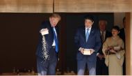 US President Donald Trump and Japan's Prime Minister Shinzo Abe feed carps before their working lunch at Akasaka Palace in Tokyo, Japan November 6, 2017. REUTERS/Jonathan Ernst