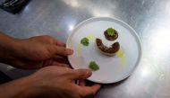 A file photo of a staff member of Ultraviolet restaurant working inside the kitchen as they prepare for their guests in Shanghai October 11, 2017. / AFP / CHANDAN KHANNA