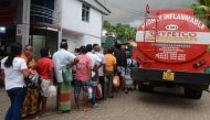 Sri Lankan commuters queue to buy petrol in Colombo on November 6, 2017. AFP