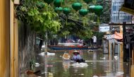 A woman wades along submerged by Typhoon Damrey houses in the UNESCO heritage ancient town of Hoi An, Vietnam November 7, 2017. REUTERS/Kham.