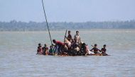 Rohingya Muslim refugees use a makeshift raft to travel from Myanmar to Bangladesh at Sha Porir Dwip in the Bangladeshi district of Teknaf on November 8, 2017. AFP