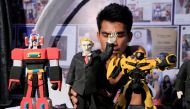 Elmer Padilla, 30, who is famous for creating action figures out of discarded slippers, makes a figure of U.S. President Donald Trump (C) at his workshop in metro Manila, Philippines, November 8, 2017. Reuters/Romeo Ranoco