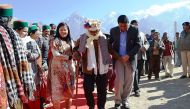 Indian voter Shyam Saran Negi (C), 100, arrives to vote in the northern Himachal Pradesh state elections in Kalpa, around 145 miles from the state capital Shimla, on November 9, 2017.  AFP / STR
