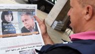 This file photo taken on August 29, 2015 shows a Moroccan man reading the latest issue of Al-Massae daily newspaper in Arabic with on its page portraits of the two French investigative journalists who have been charged in Paris with trying to blackmail th