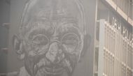 This photo taken on November 10, 2017 shows a street art painting of Indian independence icon Mahatma Gandhi on a building in New Delhi. AFP / Dominique Faget