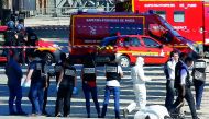 FILE PHOTO: Criminal police inspect the body of a suspect at the scene of an incident in which a car rammed a gendarmerie van on the Champs-Elysees Avenue in Paris, June 19, 2017 (Reuters / Gonzalo Fuentes) 