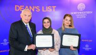 Everette E Dennis, Dean and CEO of NU-Q, with students holding certificates for excellence. 