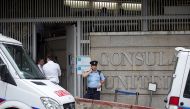 A police officer stands guard at the entry to the US consulate in Hong Kong after a suspicious envelope sparked a security alert on the premises on November 13, 2017. AFP / Vivek Prakash 