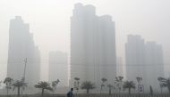 A man walks through smog near Delhi, India November 13, 2017. Reuters/Cathal McNaughton
