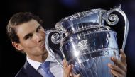 Spain's Rafael Nadal kisses the ATP World Tour No 1 Trophy at the presentation ceremony during Day One of the ATP World Tour Finals tennis tournament at the O2 Arena in London on November 12, 2017. / AFP / ADRIAN DENNIS