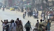 Pakistani activists of the Tehreek-i-Labaik Yah Rasool Allah Pakistan (TLYRAP) religious group search a motorcyclist along a blocked highway during a week long protest in Islamabad on November 13, 2017. (AFP / AAMIR QURESHI)