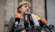 German Chancellor Angela Merkel, also leader of the conservative Christian Democratic Union (CDU) party, gives a statement as she arrives for further exploratory talks with members of potential coalition parties to form a new government on November 16, 20
