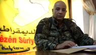 This file photo taken on November 17, 2015 shows Syrian Democratic Forces (SDF) spokesman Talal Ali Sello posing for a photo during an interview with AFP in the coalition's headquarters in the northeastern Syrian city of Hasakeh. AFP / Delil Souleiman