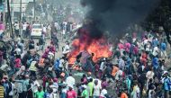 Supporters of Kenyan's opposition party National Super Alliance (NASA) react following the sound of gunshots during a demonstration on November 17, 2017 in Nairobi.  AFP / Yasuyoshi Chiba