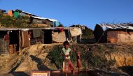 A Rohingya refugee girl collects drinking water from a tube-well in the Jamtoli refugee camp in Cox's Bazar, Bangladesh November 18, 2017. REUTERS/Mohamamd Ponir Hossain
