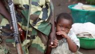 A file photo of a Congo girl holding a fighters hand. Reuters.