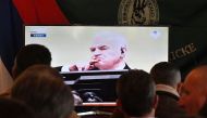 Former Bosnian Serbian commander Ratko Mladic appears on a TV screen wher people gather to watch a live broadcast from the International Criminal Tribunal for the former Yugoslavia (ICTY) on November 22, 2017 in Sokolac. AFP / Elvis Barukcic