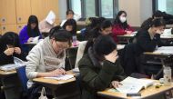 Students prepare to take the annual College Scholastic Ability Test, a standardised exam for college entrance, at a high school in Seoul on November 23, 2017. / AFP / JUNG Yeon-Je