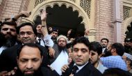 Hafiz Saeed (C) reacts to supporters as he walks out of court after a Pakistani court ordered his release from house arrest in Lahore, Pakistan November 22, 2017. REUTERS/Mohsin Raza
