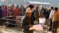A Nepali voter examines a ballot papers before casting his vote at a polling station during the general election at Chautara, Sindhupalchowk district some of 100 kilometers east of Kathamndu on November 26, 2017./ AFP.