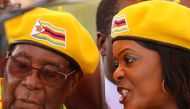 President Robert Mugabe listens to his wife Grace Mugabe at a rally of his ruling ZANU-PF party in Harare, Zimbabwe, November 8, 2017. Picture taken November 8, 2017. REUTERS/Philimon Bulawayo