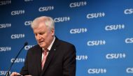 Bavaria's State Premier and leader of the Christian Social Union (CSU) party, Horst Seehofer checks his mobile phone prior a press conference after the CSU meeting at the party headquarters in Munich, southern Germany, on November 23, 2017. / AFP / CHRIST
