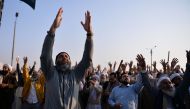Pakistani protesters from the Tehreek-i-Labaik Yah Rasool Allah Pakistan (TLYRAP) religious group shout religious slogans during a protest in Islamabad on November 26, 2017. / AFP / AAMIR QURESHI