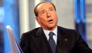 A file photo of Italy's former Prime Minister Silvio Berlusconi gestures as he attends television talk show 