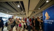 Passengers gather at the Ngurah Rai International airport in Denpasar, Bali on November 28, 2017 to wait for possible flights out. AFP / JUNI KRISWANTO