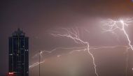 Lightning strikes behind commercial tower near a financial city in Colombo, Sri Lanka. / Image: REUTERS/Dinuka Liyanawatte.