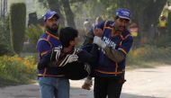Rescue workers assist an injured student from the shooting at Directorate of Agriculture Institute in Peshawar, Pakistan December 1, 2017. Reuters/Fayaz Aziz
