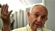 Pope Francis gestures during a news conference on board of the plane during his flight back from a trip to Myanmar and Bangladesh, December 2, 2017. REUTERS/Vincenzo Pinto/Pool.