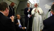 Pope Francis speaks to reporters during a news conference on board of a plane on December 2, 2017, during a flight back from a seven-day trip to Myanmar and Bangladesh./ AFP.