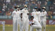 An image of Sri Lankan cricket players wearing masks in an attempt to protect themselves from air pollution during the second day of the third Test cricket match between India and Sri Lanka in New Delhi December 3, 2017. / AFP / SAJJAD HUSSAIN / 
