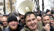 Former Georgian Mikheil Saakashvili (C-R) smiles after he was released by his supporters in downtown Kiev on December 5, 2017.   AFP / Sergei CHUZAVKOV
