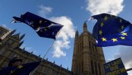 An anti-Brexit protestor flies flags near the Houses of Parliament in London, Britain, December 8, 2017. (REUTERS/Toby Melville)