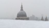 St Paul's Cathedral is seen as snow falls over central London on December 10, 2017. / AFP / DANIEL SORABJI