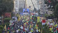 Lebanese demonstrators march with their national flags and the flags of Palestine and the militant Shiite movement Hezbollah during a protest against the US president's controversial recognition of Jerusalem as Israel's capital, in Beirut on December 11, 
