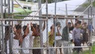 A file photo of Asylum-seekers looking through a fence at the Manus Island detention centre in Papua New Guinea. Reuters