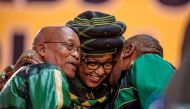 Former wife of the late South African President Nelson Mandela, Winnie Mandela (C), hugs South African President Jacob Zuma (L) and Deputy President Cyril Ramaphosa as they attend the 54th ANC National Conference at the NASREC Expo Centre in Johannesburg 