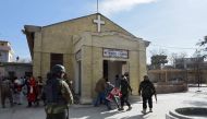 Pakistani security personnel rescue an injured woman after suicide bombers attacked a Methodist Church during a Sunday service in Quetta on December 17 2017.  AFP / BANARAS KHAN
