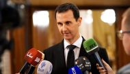 A handout picture released by the Syrian Arab News Agency (SANA) on December 18, 2017 shows Syrian President Bashar al-Assad speaking to the press after receiving a Russian delegation in Damascus. AFP PHOTO / HO / SANA