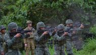 An Australian soldier (back L) supervises as Philippine Marines fire their weapons during a demonstration at Military Operation Urbanized Terrain (MOUTH) training exercises at the marine base in Ternate, Cavite province, southwest of Manila on December 18