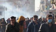 Kurdish protesters run away from tear gaz during a rally against the Kurdistan Regional Government (KRG) in Sulaimaniyah, Iraq December 18, 2017. REUTERS/Stringer. 
