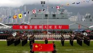 A file photo of People's Liberation Army Navy soldiers take part in a parade with a banner 