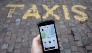 FILE PHOTO: A photo illustration shows the Uber app on a mobile telephone, as it is held up for a posed photograph, in London, Britain, November 10, 2017. REUTERS/Simon Dawson/File Photo

